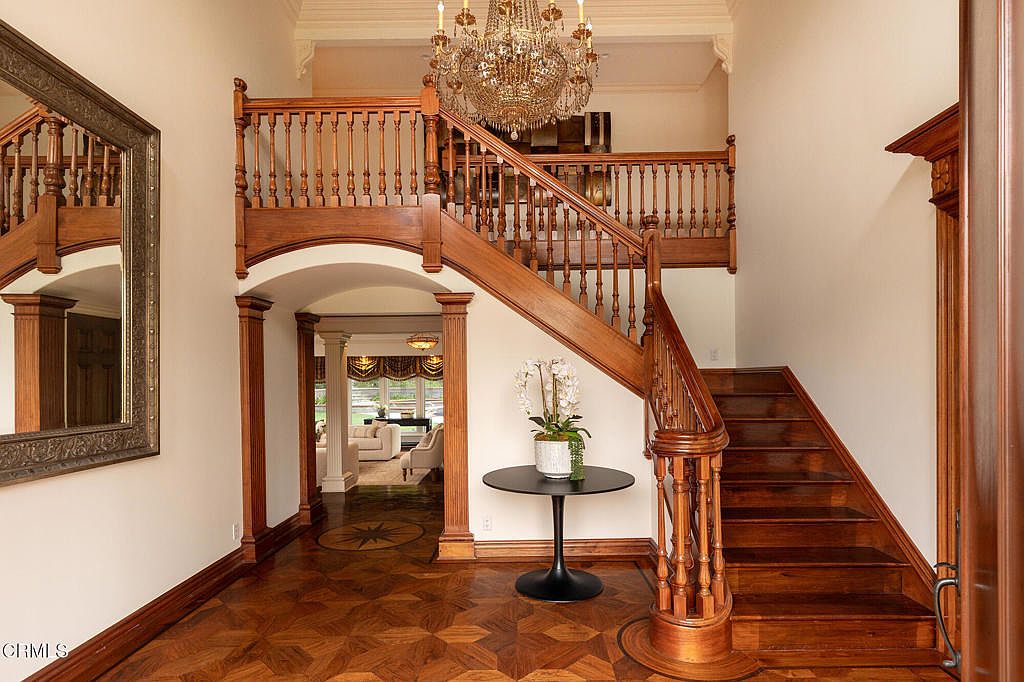 Step-down living room with carved wood fireplace.